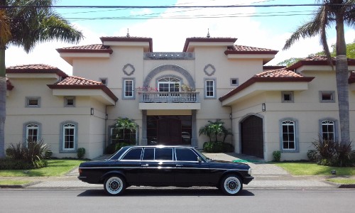 LIMOUSINE IN FRONT OF LARGE MANSION COSTA RICA